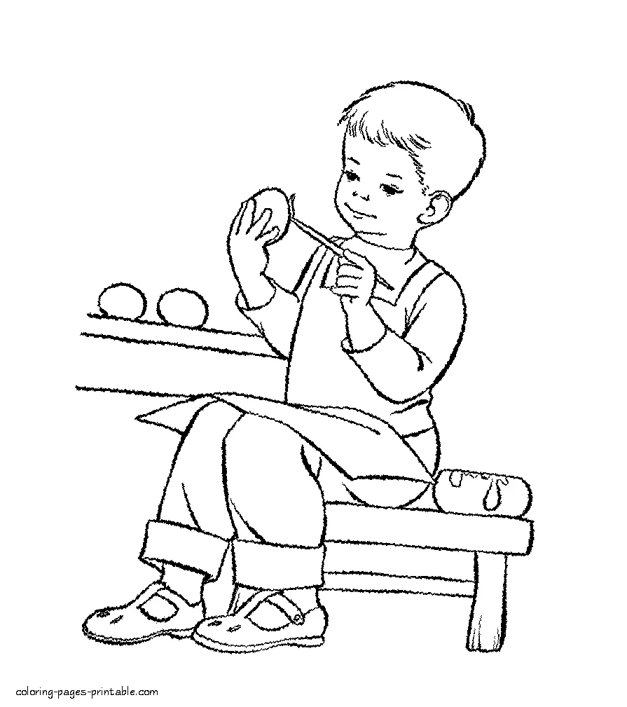 Boy paints eggs Boy paints Easter eggs