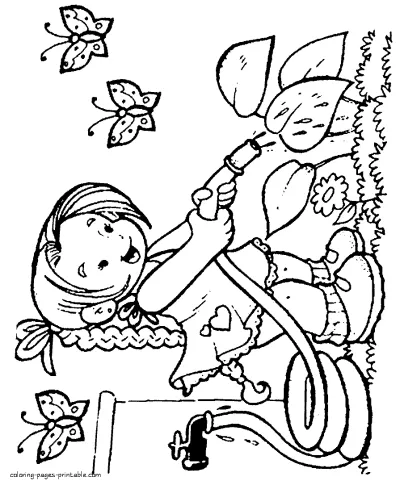 Girl who water the plants in spring garden